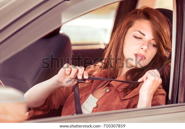 Beautiful young woman in the nice car is going\
to vacation.