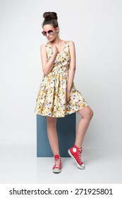 Beautiful Young Woman In Nice Spring Dress, Flower Pattern Posing In Studio. Fashion Photo