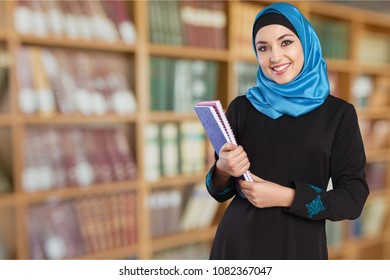 Beautiful young woman with notebooks