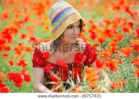 beautiful young woman on field with poppies