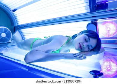 Beautiful young woman on sunbed