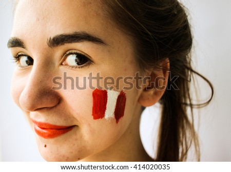 Beautiful young woman with painted austria chile flag on face football olympic games supporter