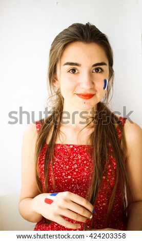 Beautiful young woman with painted french flag on face, hand & manicure, olympic games supporter
