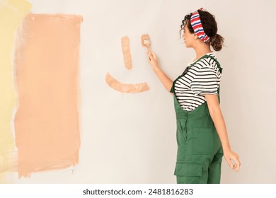 Beautiful young woman painting wall during repair in new house - Powered by Shutterstock