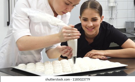 Beautiful Young Woman Pastry Chef Smiling To The Camera At The Bakery Kitchen
