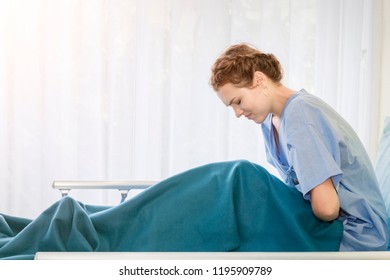 Beautiful Young Woman Patient With Period Pain On Hospital Bed Room.Copy Space.