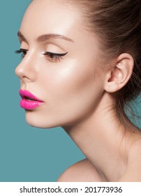 Beautiful Young Woman With Pink Lips And Healthy Skin On A Blue Background. Trendy Summer Makeup