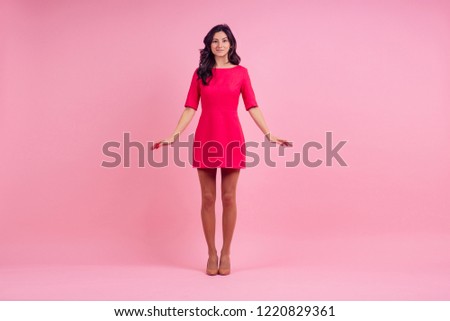 beautiful young woman in pink mini dress posing length studio shot on pink background. Barbie doll stylish look