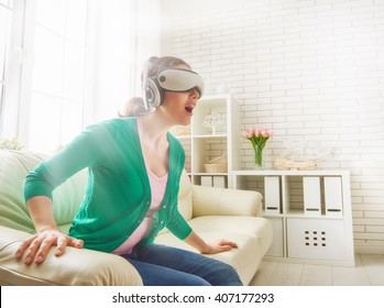 Beautiful Young Woman Playing Game In Virtual Reality Glasses.