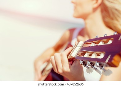 Beautiful Young Woman Playing Guitar On Beach