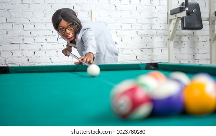 Beautiful young woman playing pool game. - Powered by Shutterstock