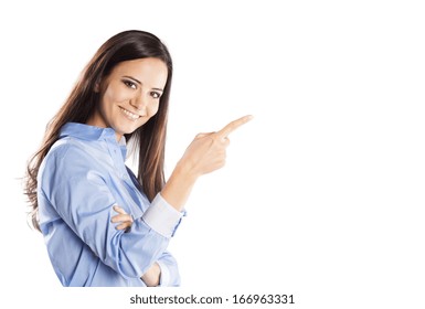 Beautiful young woman pointing to somewhere, isolated over a white background