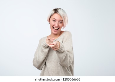 Beautiful Young Woman Points With Finger And Scoffs, Short Haircut