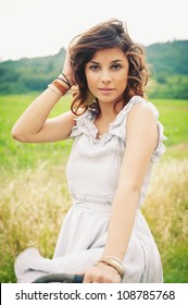 Beautiful Young Woman Portrait With Bike In A Country Road.