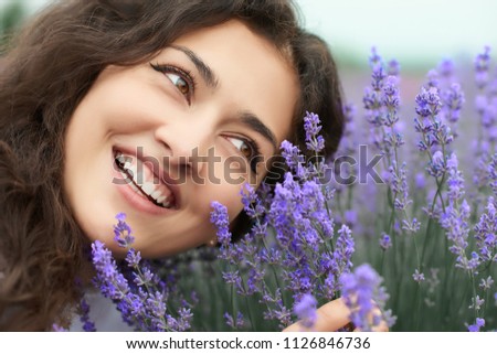 beautiful young woman portrait on lavender flowers background, face closeup