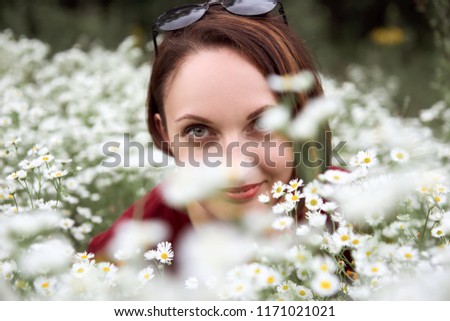 beautiful young woman portrait on white wild flowers background, face closeup