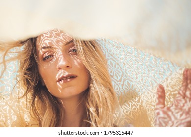 Beautiful young woman portrait under silk