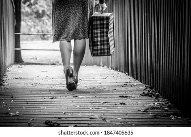Beautiful young woman posing in vintage 1940s clothes, on a bridge, focussing on legs