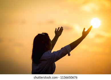 Beautiful young woman raised his hand in front of the sun.
promise
Gratitude
pray
Ask God to help him. - Powered by Shutterstock