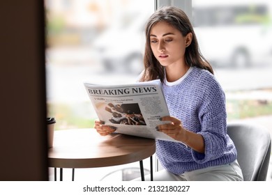 Beautiful young woman reading newspaper at table in cafe - Powered by Shutterstock