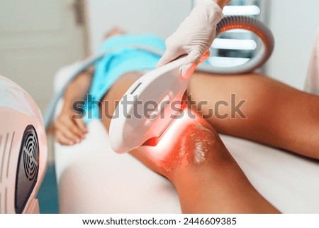 Beautiful young woman receiving professional laser hair removal treatment. Modern beauty epilation.
