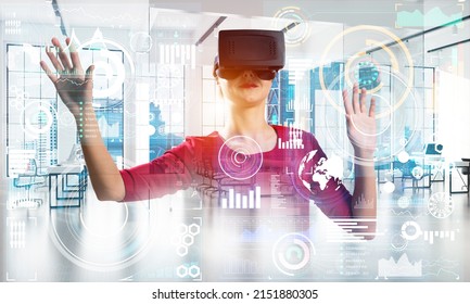 Beautiful And Young Woman In Red Dress Using Virtual Reality Headset With Digital Media Structure While Standing Inside Office. Up To Date Technologies