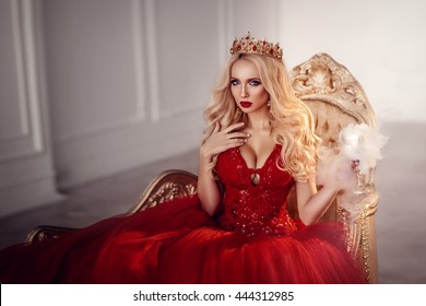 Beautiful young woman in red dress. Queen. Portrait