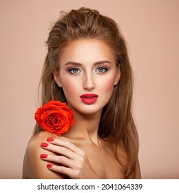 Beautiful young woman with a red flower in hand near face.  Portrait of white girl with red rose in hands. Beauty face concept. Art portrait of an attractive model. Girl with bright fashion makeup - Shutterstock ID 2041064339