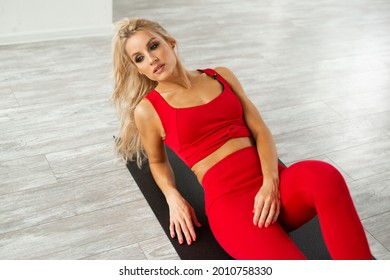 Beautiful Young Woman In Red Tracksuit Doing Yoga	
