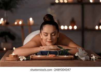 Beautiful young woman relaxing in dark spa salon - Powered by Shutterstock