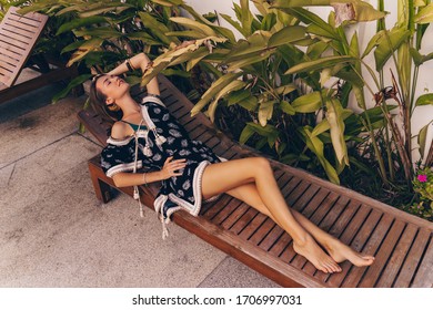 Beautiful  Young Woman Relaxing  On Private Villa Near Pool. Boho Chic,style And Beauty, Fashionable Girl,accessory Store. Tropical Stile.