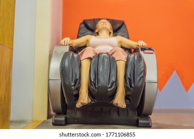 Beautiful Young Woman Relaxing On The Massage Chair In Airport Or In The Mall