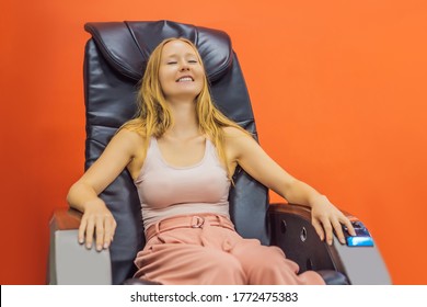 Beautiful Young Woman Relaxing On The Massage Chair In Airport Or In The Mall