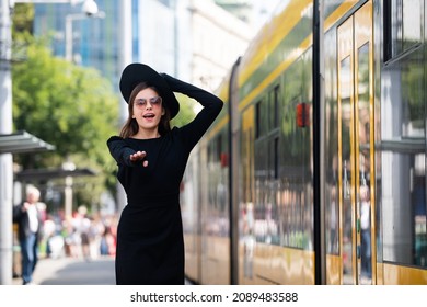 Beautiful Young Woman Running After Trolleybus Bus In The City Street. Beautiful Young Fashion Woman. Traveling In City.