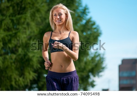 Similar – Woman in sports wear with earphones looking smartphone