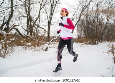 A Beautiful Young Woman Running At Winter Forest