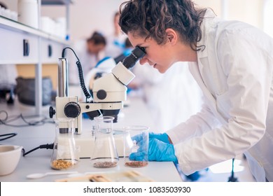 Beautiful young woman scientist in laboratory working. Young female scientist doing some research.