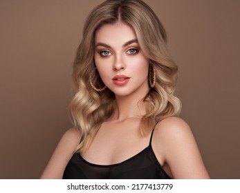 A Beautiful Young Woman With Shiny Wavy Blonde Hair. Model With Healthy Skin, Close Up Portrait. Cosmetology, Beauty And Spa