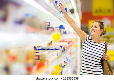 Beautiful Young Woman Shopping For Diary Products At A Grocery Store/supermarket (color Toned Image)