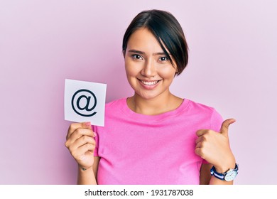 Beautiful Young Woman With Short Hair Holding Paper With Email Symbol Smiling Happy And Positive, Thumb Up Doing Excellent And Approval Sign 