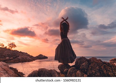 beautiful young woman silhouette on sunset