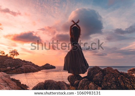beautiful young woman silhouette on sunset