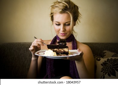 Beautiful Young Woman Sitting And Eating Cake