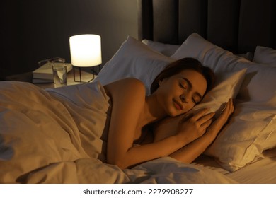 Beautiful young woman sleeping in bed at night - Shutterstock ID 2279908277