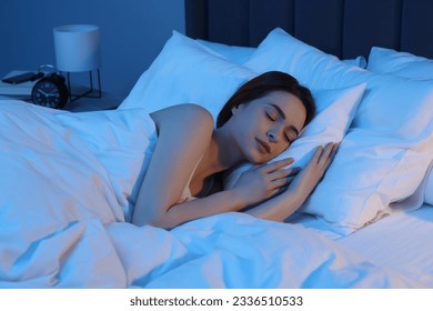 Beautiful young woman sleeping in bed at night - Powered by Shutterstock