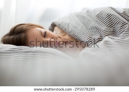 Beautiful young woman sleeping in bed