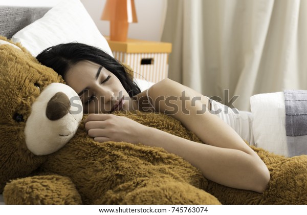 girl hugging huge teddy bear