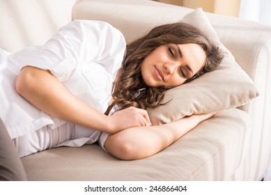 Beautiful Young Woman Is Sleeping And Seeing Sweet Dreams.