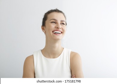 Beautiful Young Woman Smiling Against White Background. 