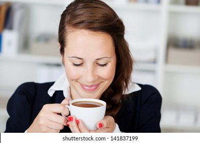 Beautiful Young Woman Smiling With Bliss And Anticipation While Enjoying A Cup Of Coffee